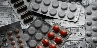Close-up of various pills in blister packs showcasing medical and healthcare themes.